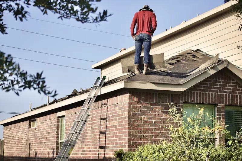 Professional roofer working on a residential roof in Holly Spring